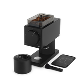 Black coffee grinder on a white background. fellow brand, Ode Brew Grinder Generation 2 and accessories, brush. 